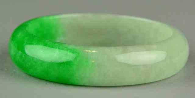 Appraisal: Chinese Jadeite Bangle or BraceletFinely polished emerald green and light