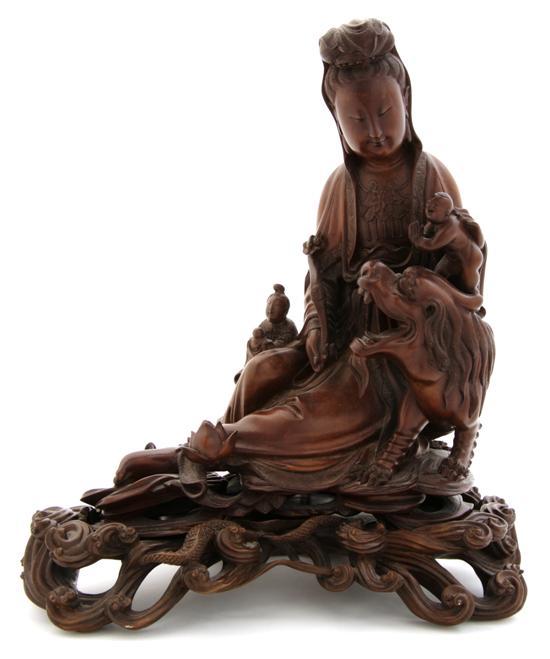 Appraisal: A Chinese Carved Wood Figure of Guanyin depicted with two