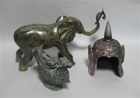 Appraisal: THREE ARCHAISTIC CHINESE BRONZE WORKS OF ART Comprising a helmet