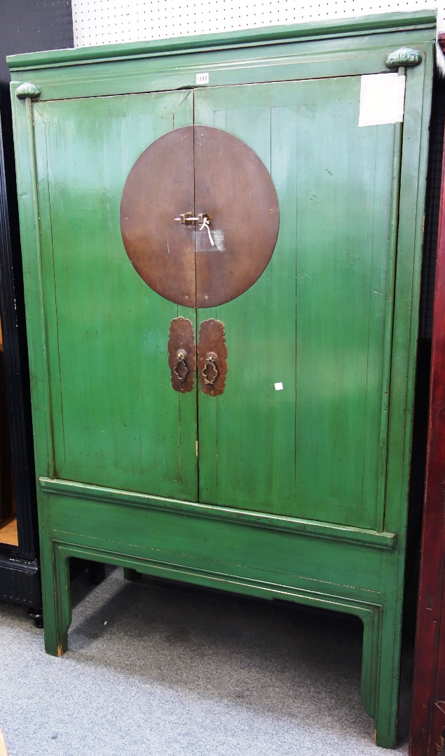 Appraisal: A late th century Chinese green painted two door cupboard