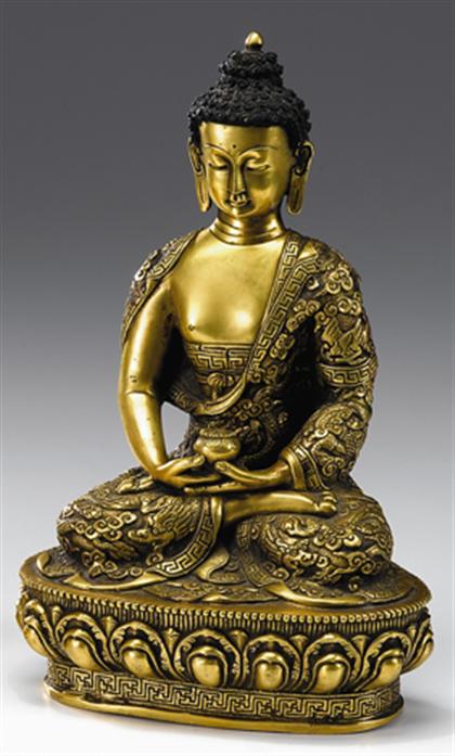 Appraisal: Tibetan gilt bronze figure of Shakyamuni Seated in vajrasana supporting