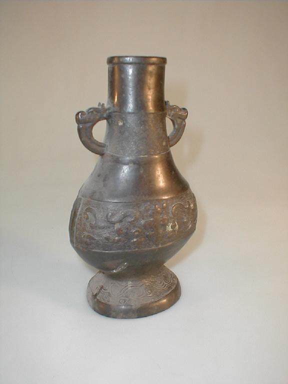 Appraisal: A Chinese bronze flask shape vase with elephant head handles