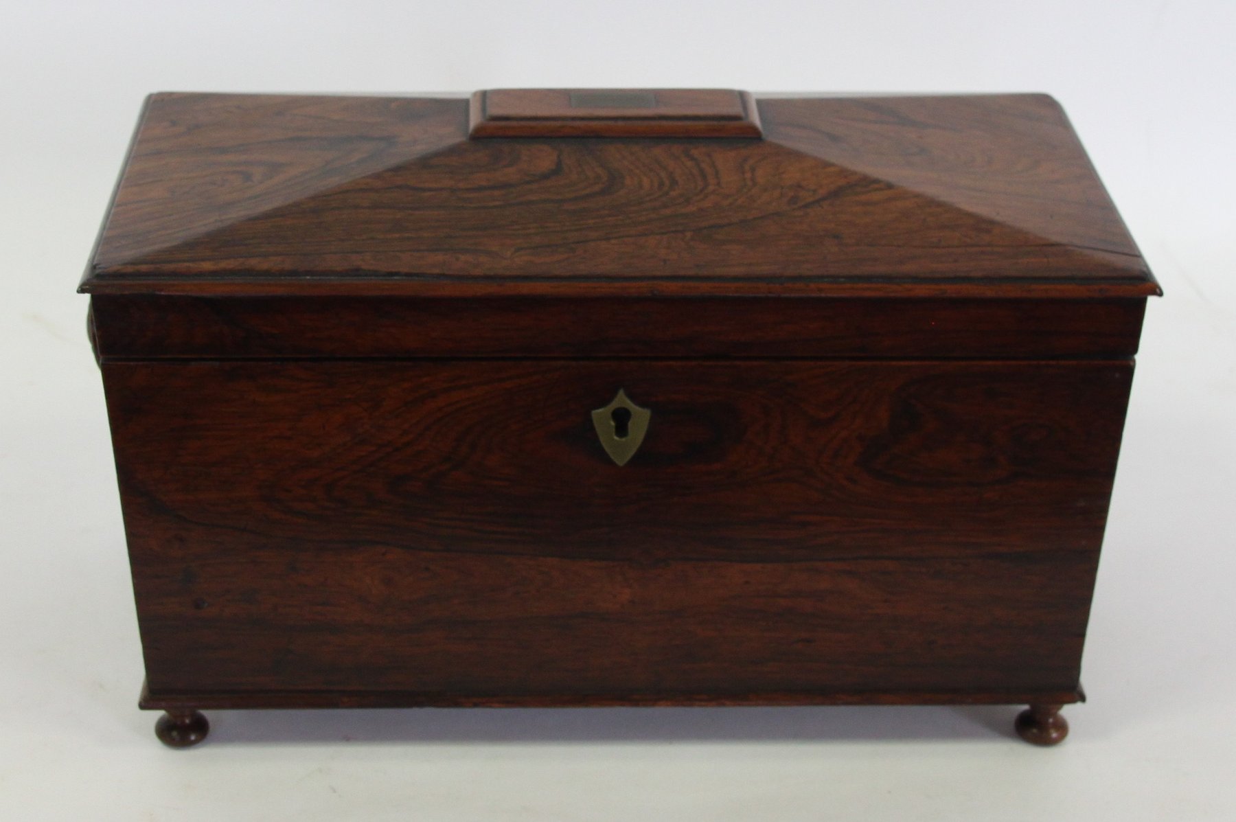 Appraisal: A Regency rosewood tea caddy of sarcophagus shape the interior