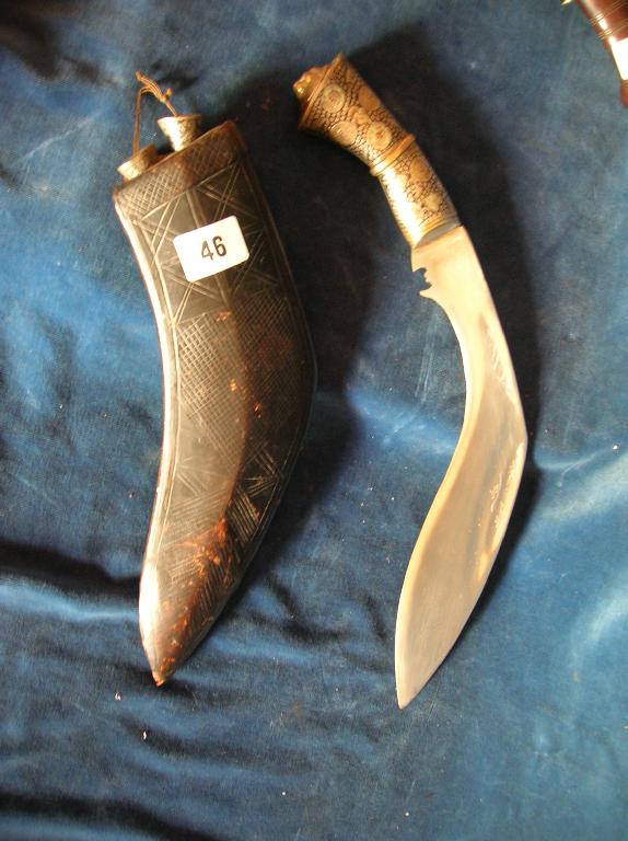 Appraisal: A Nepalese kukri with plated blade and white metal hilt