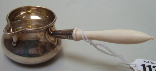 Appraisal: A Victorian silver brandy warming saucepan London with an ivory