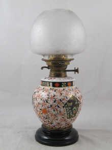 Appraisal: A late Victorian oil lamp the ceramic body and drop