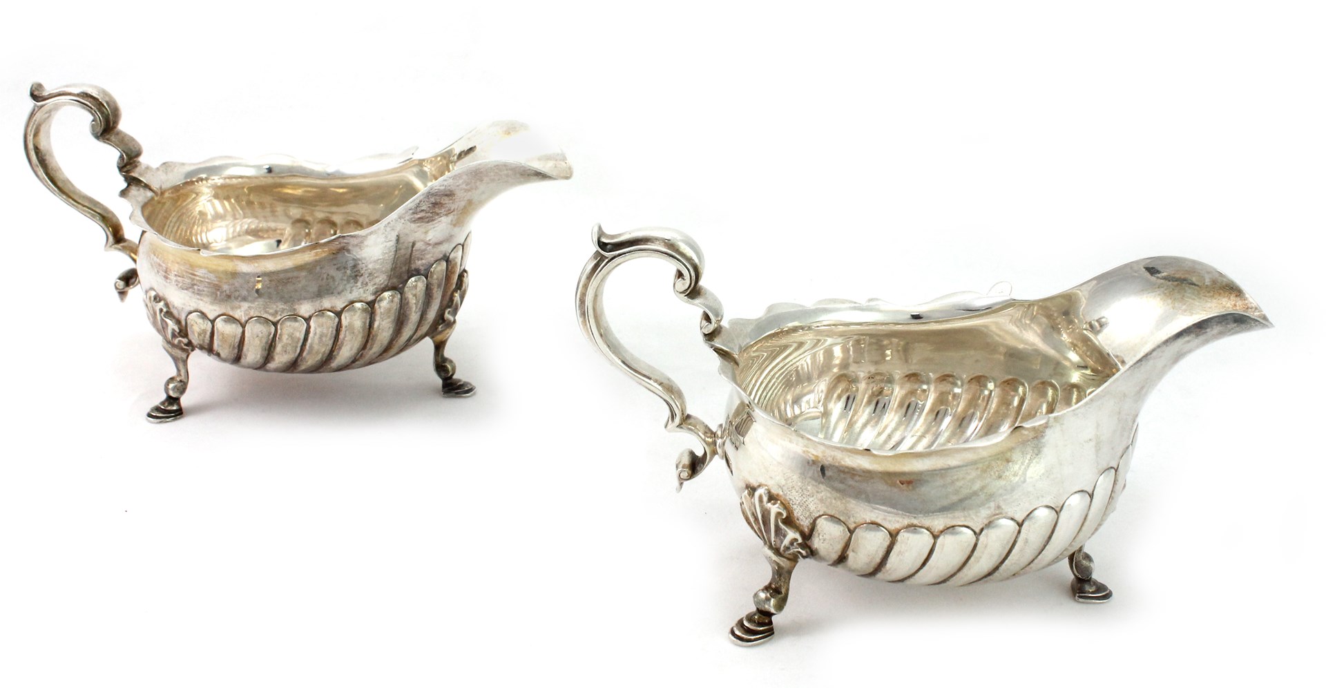 Appraisal: A pair of silver sauceboats each with partly fluted decoration