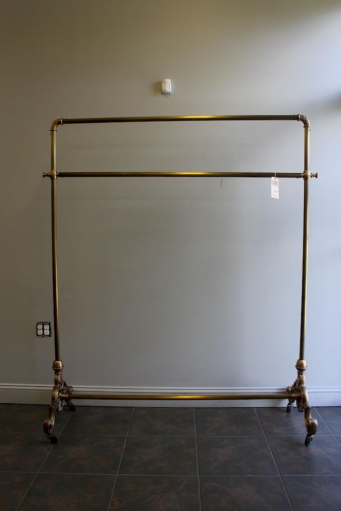 Appraisal: URBAN ARCHAEOLOGY Pair Of Gilt Metal Rolling Racks Nice sturdy