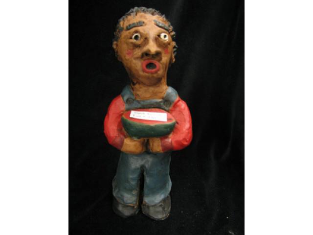 Appraisal: Folk Art Red Clay Figurine of Black Boy holding a