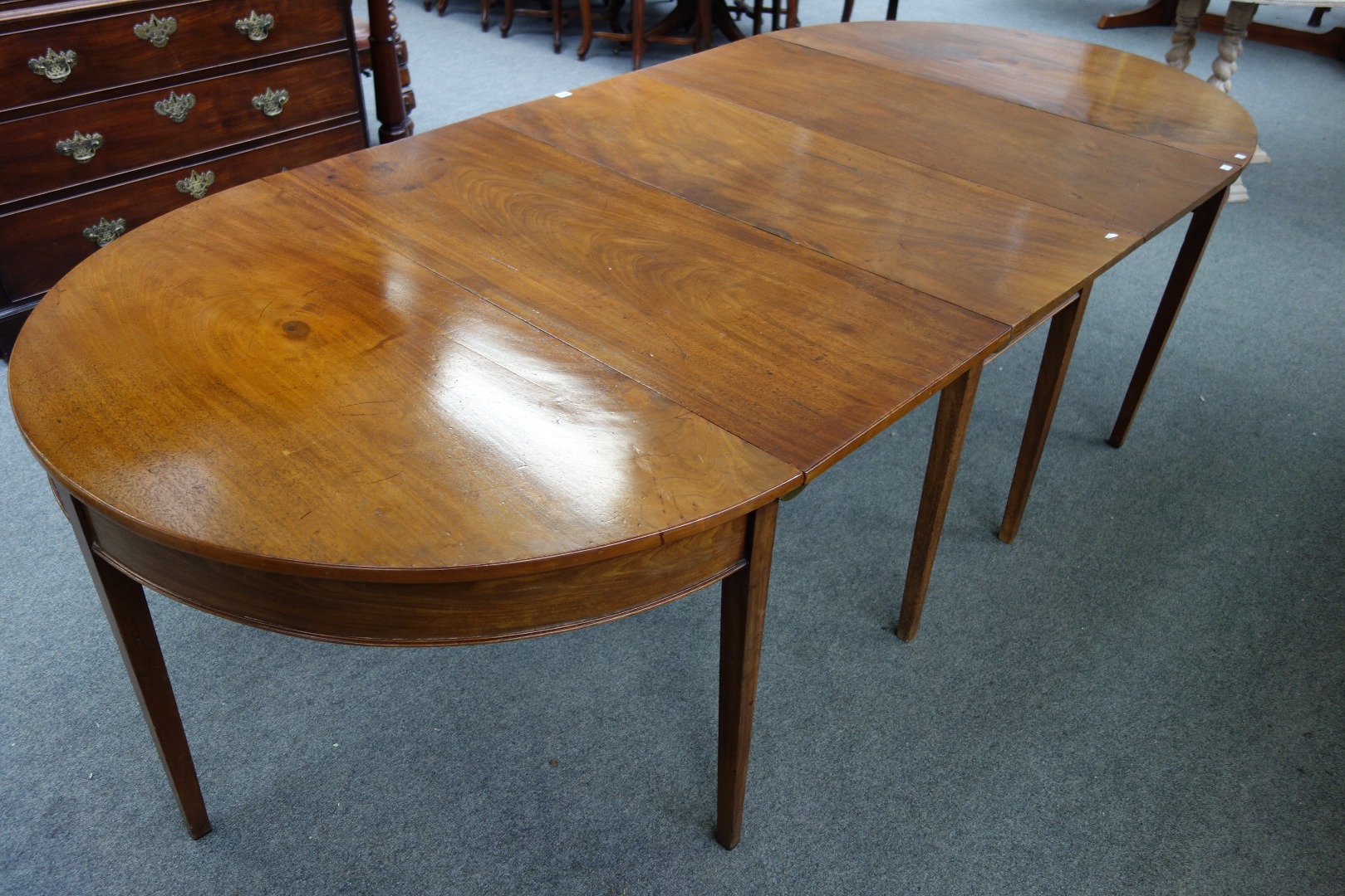 Appraisal: A George III mahogany D-end extending dining table with drop-flap