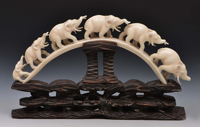 Appraisal: Carved ivory graduated train of elephantson a hardwood stand circa