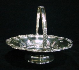 Appraisal: An electro silver plate swing handled basket with crossed arrow