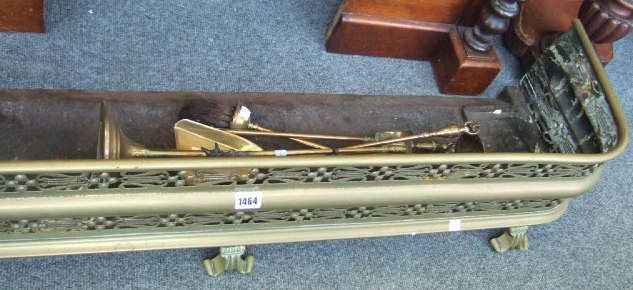 Appraisal: A pierced brass 'D' shaped fire fender and a brass