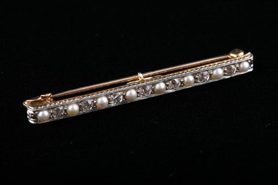 Appraisal: EDWARDIAN PLATINUM-ON-YELLOW GOLD DIAMOND AND SEED PEARL BAR PIN Seven