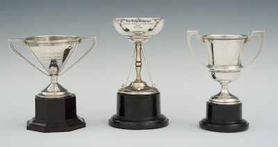 Appraisal: Three Small Trophies on Plastic Bases Including two different double