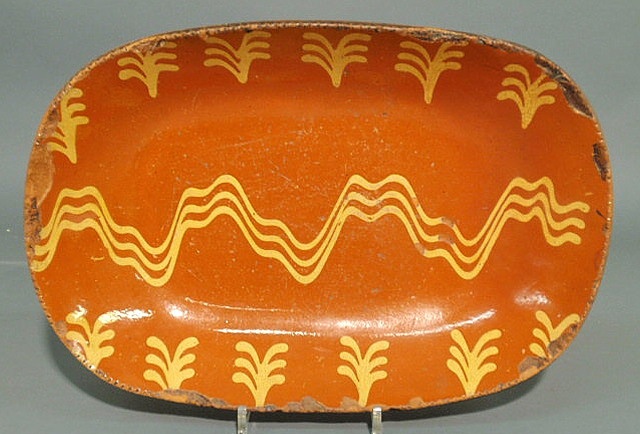 Appraisal: Pennsylvania redware loaf dish th c with yellow slip decoration