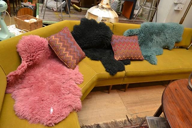 Appraisal: THREE COLOURED SHEEP SKIN RUGS THREE COLOURED SHEEP SKIN RUGS