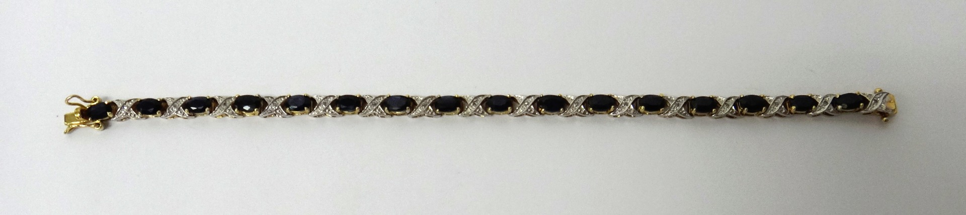 Appraisal: A sapphire and diamond bracelet claw set with a row