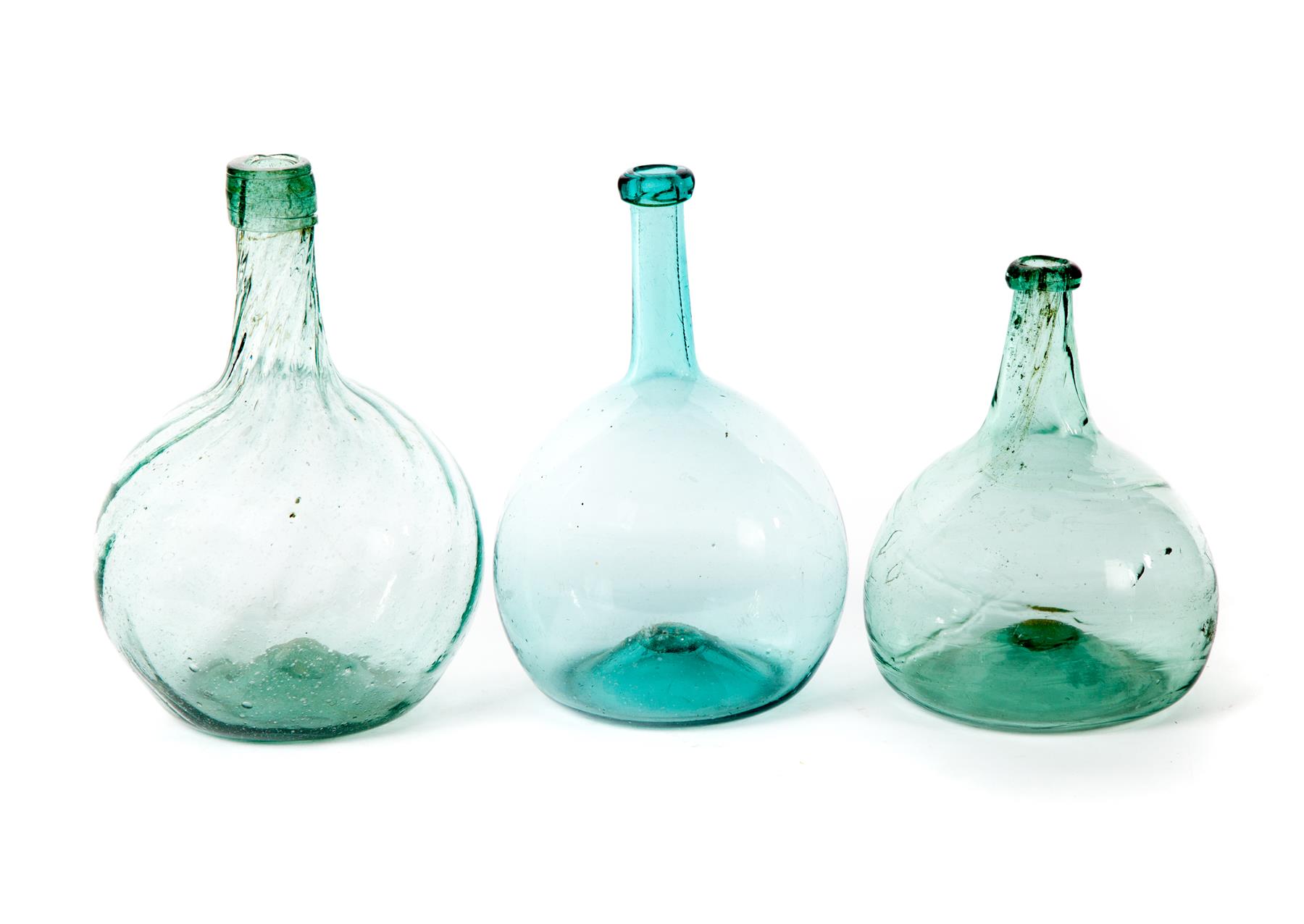 Appraisal: THREE BLOWN GLASS BOTTLES American mid th century Aqua bottle