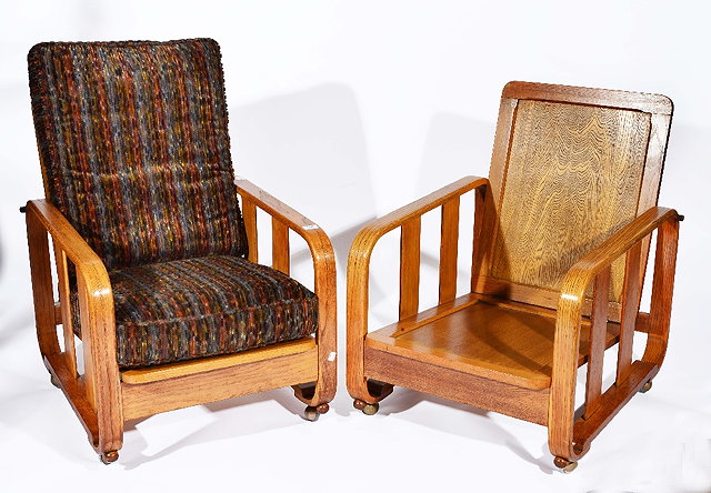 Appraisal: Pair of Heals oak recliner easy chairs from the catalogue