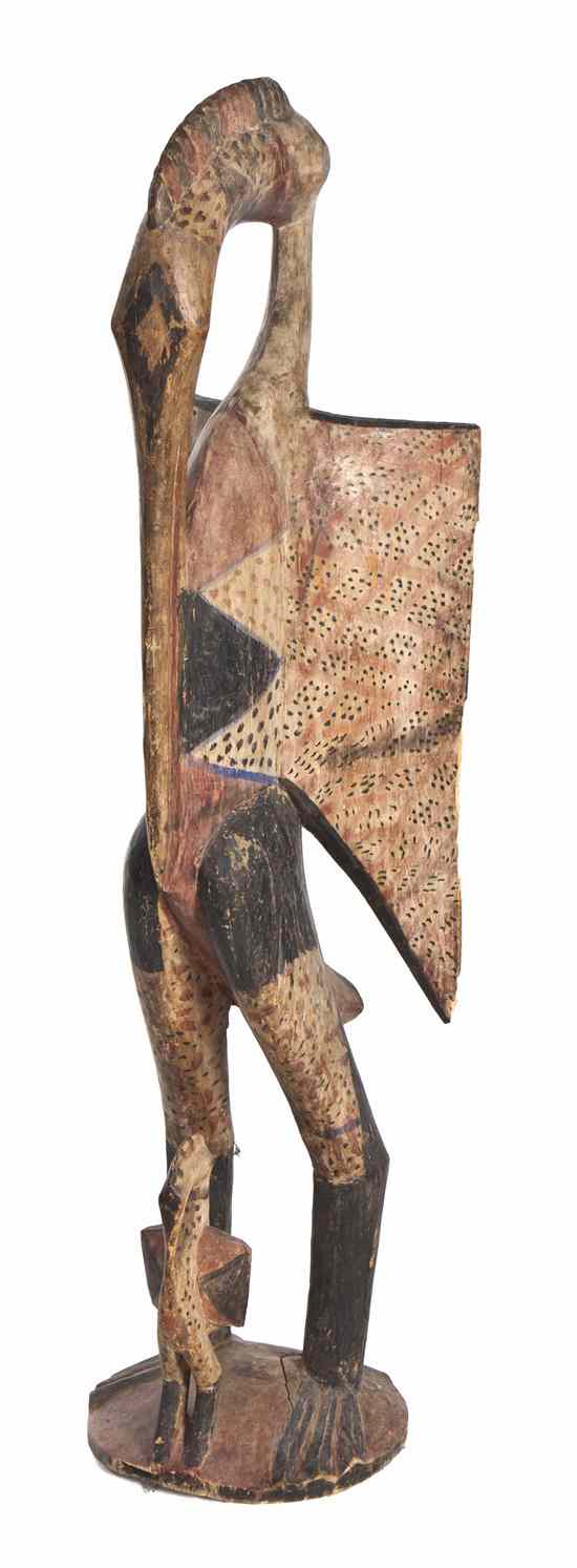 Appraisal: A Carved and Polychrome Decorated Senufo Figure depicting a standing