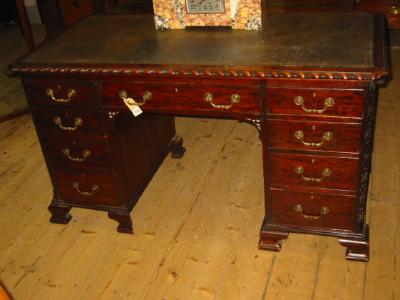 Appraisal: A MAHOGANY PEDESTAL DESK of Georgian design canted oblong top