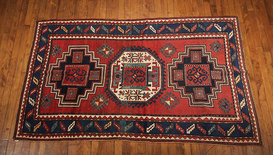 Appraisal: Kazak Rug Circa Red ground with latchhook medallion enclosing three