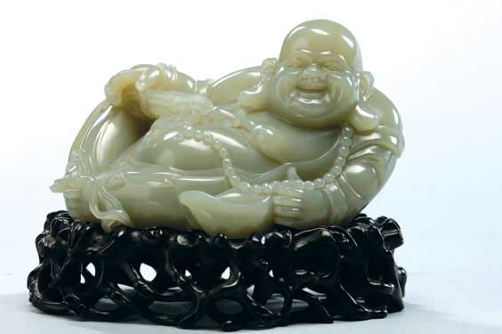 Appraisal: CARVED JADE BUDAI Chinese jade model of a reclining Budai