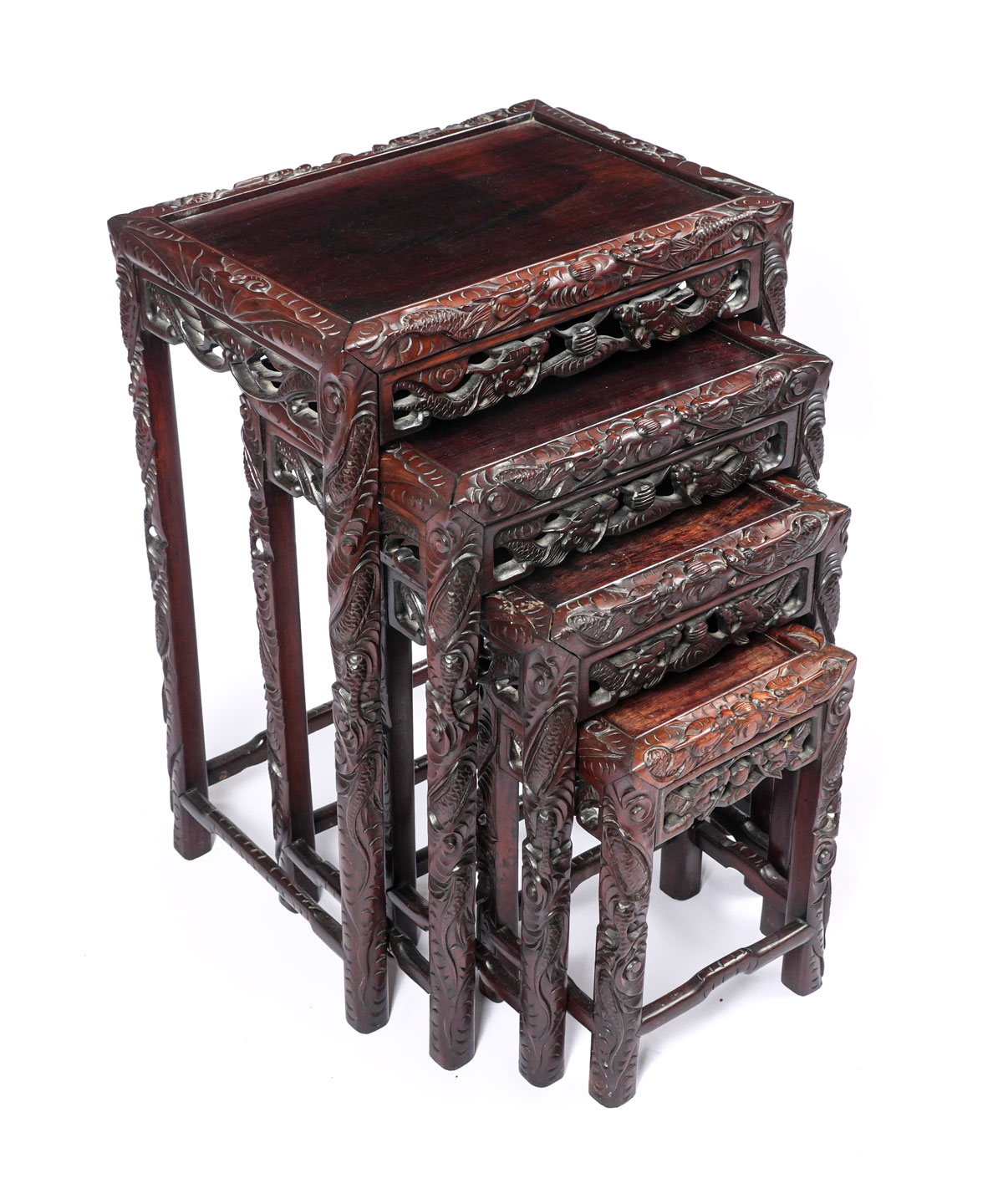 Appraisal: HIGHLY CARVED CHINESE NESTING TABLES Chinese nesting tables having a