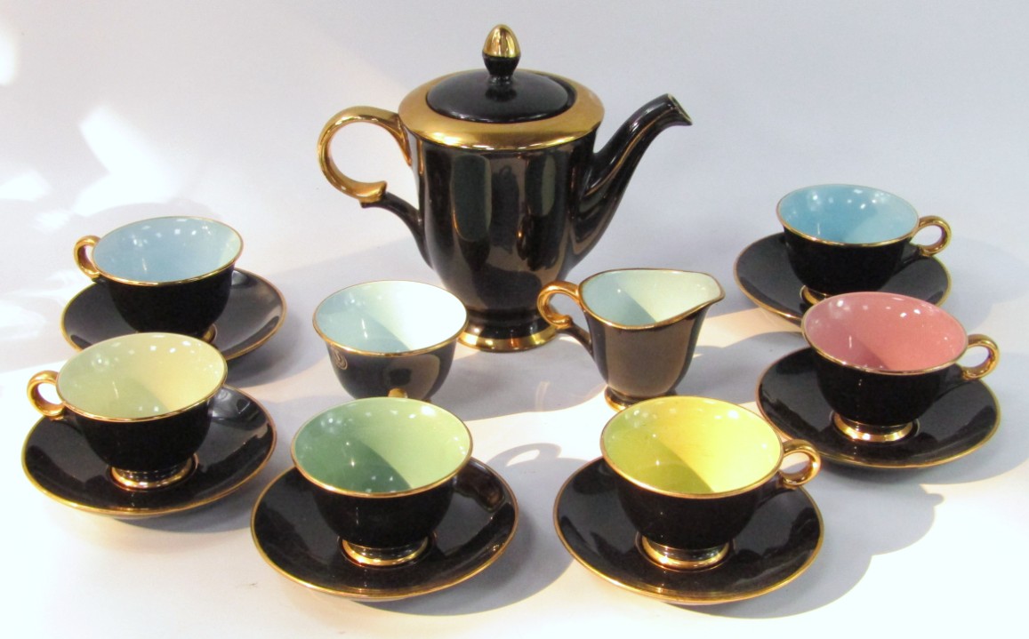 Appraisal: A Stavanger Flint harlequin pottery part coffee service black ground