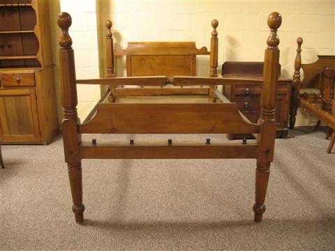 Appraisal: AMERICAN CHERRY BED Nineteenth century the octagonal shaped post surmounted