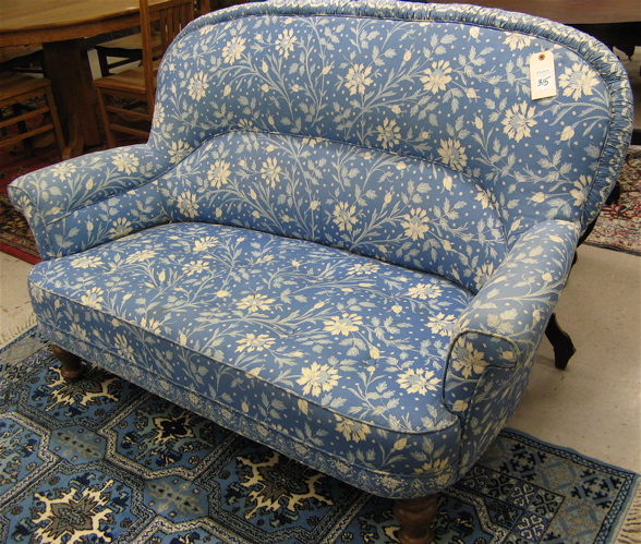 Appraisal: BLUE CHINTZ UPHOLSTERED LOVESEAT with overall blue calico cloth cover