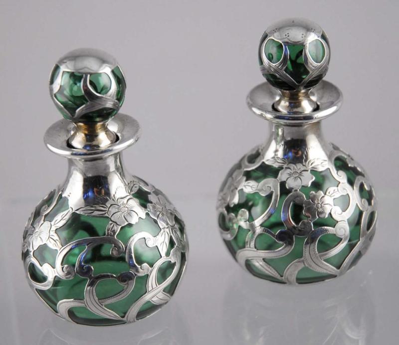 Appraisal: Pair of Sterling Silver Overlay Perfume Bottles Description Green glass