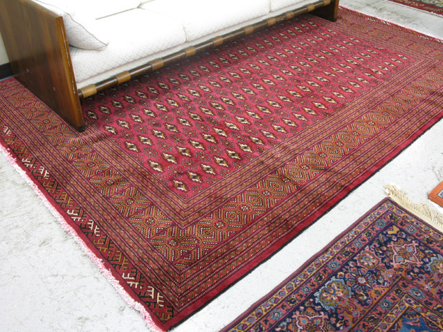 Appraisal: PERSIAN TURKOMAN CARPET repeating columns of Turkoman gols on red