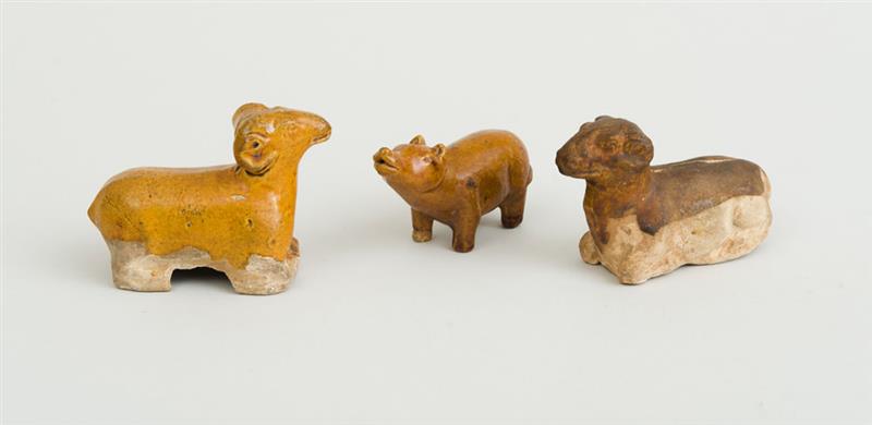 Appraisal: TANG TYPE OCHRE-GLAZED POTTERY FIGURE OF A SEATED RAM AN