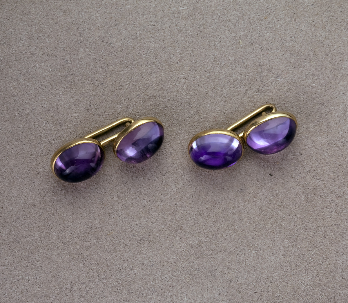 Appraisal: PAIR OF AMETHYST AND GOLD CUFFLINKS Each set with cabochon