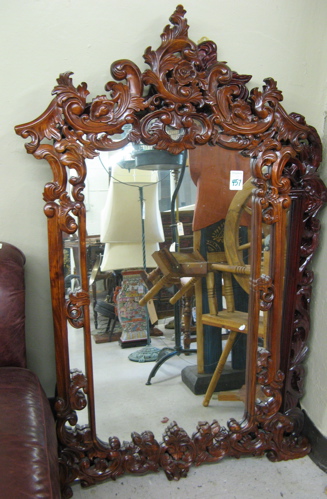 Appraisal: LOUIS XIV STYLE WALL MIRROR having a highly carved mahogany