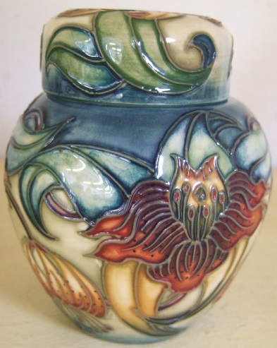 Appraisal: A Moorcroft vase and cover tube line decorated in the