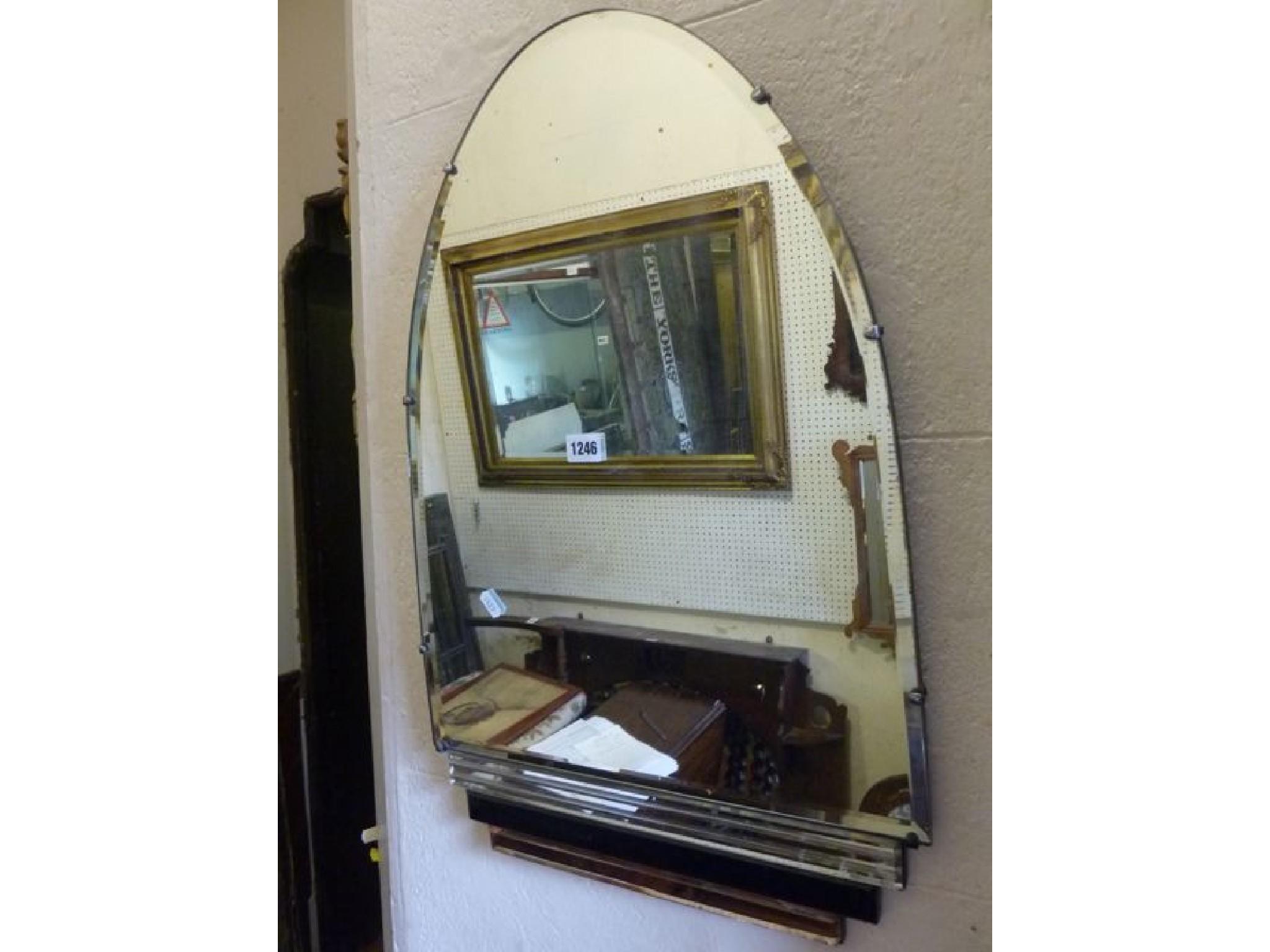 Appraisal: An Art Deco style frameless wall mirror of arched form