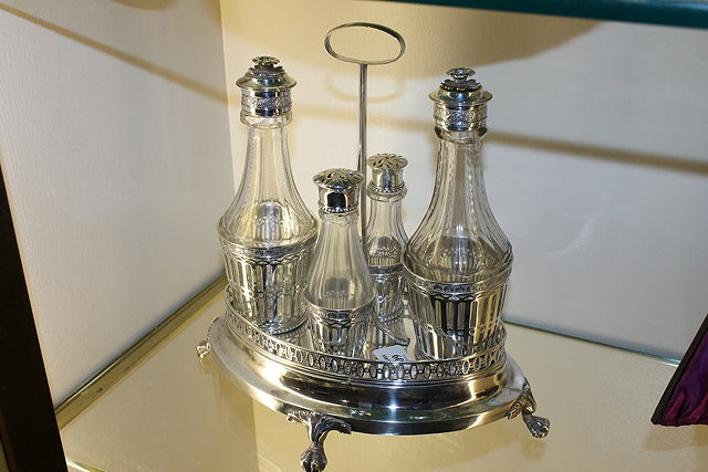 Appraisal: A SWEDISH SILVER OVAL CRUET with four glass bottles the