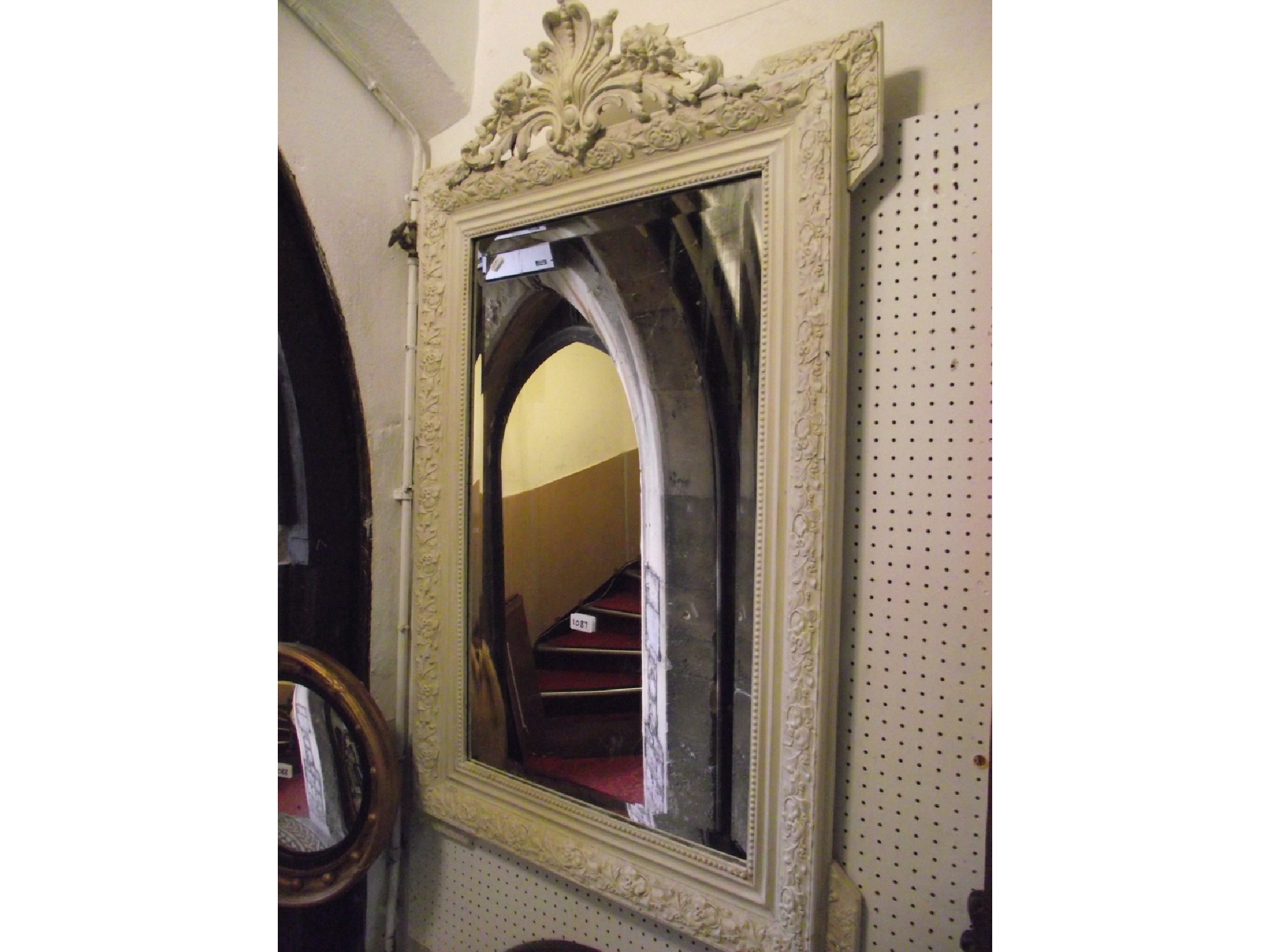 Appraisal: A large decorative wall mirror with a bevelled plate set