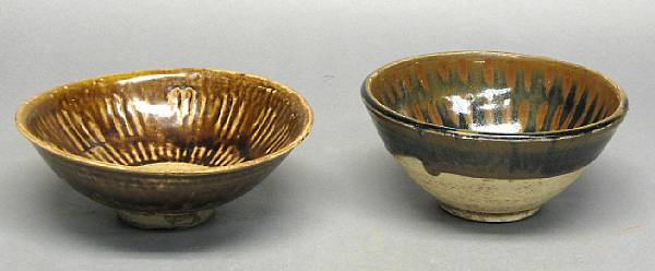 Appraisal: Two iron glazed stoneware bowls th th Century The first