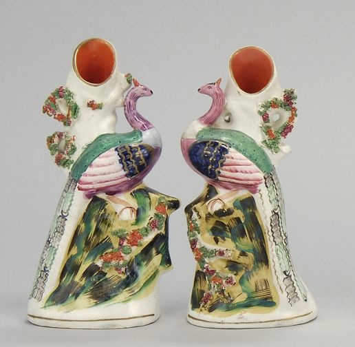 Appraisal: PAIR OF PEACOCK-FORM SPILLS Circa With polychrome decoration Peacocks perched