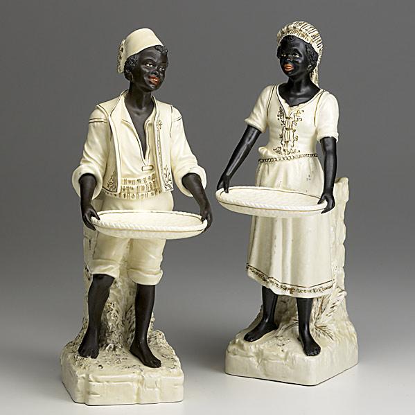 Appraisal: PAIR OF AFRICAN FIGURESPainted bisque th th c Both holding