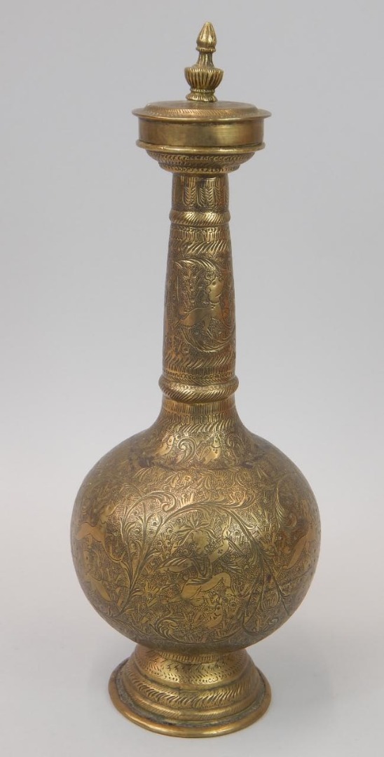 Appraisal: A Middle Eastern engraved bottle shaped vase and cover decorated