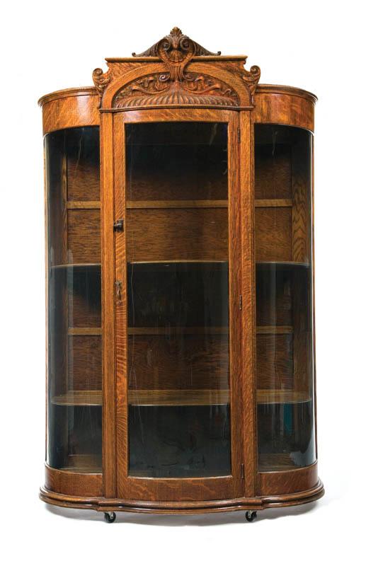 Appraisal: CHINA CABINET Oak having a shell carved crest and bowed