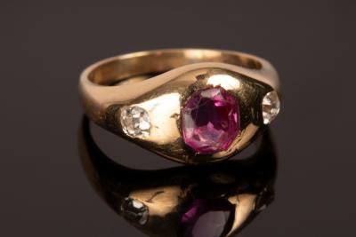 Appraisal: A ruby and diamond three-stone ring in an unmarked yellow