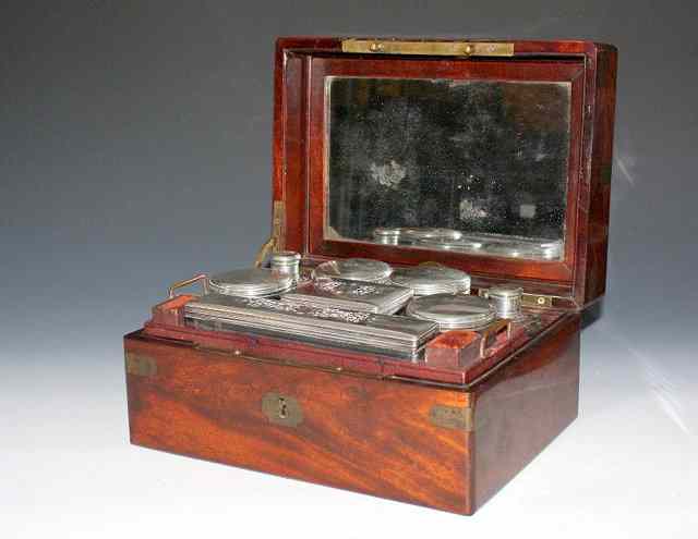 Appraisal: A FRENCH MAHOGANY BRASS BOUND TRAVELLING CASE with eight silver