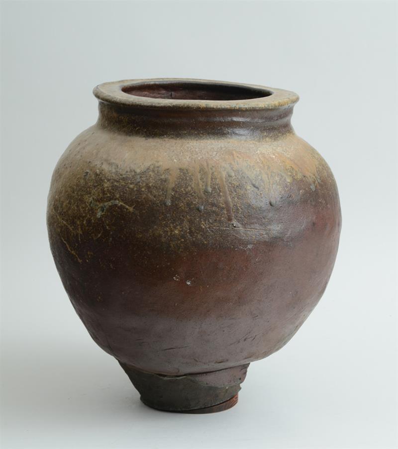 Appraisal: JAPANESE BROWN-GLAZED STONEWARE WATER JAR The ovoid bowl with recessed