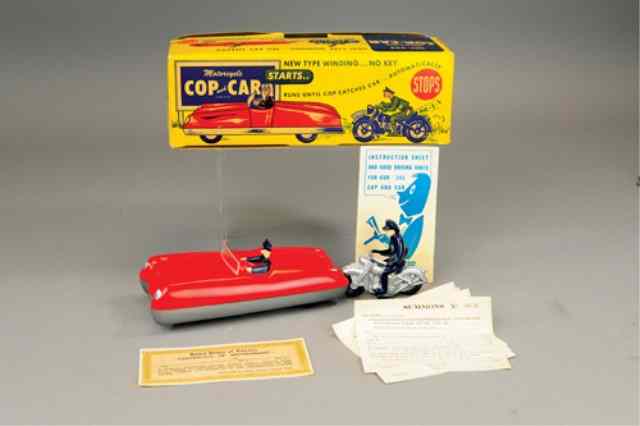 Appraisal: AUTOMATIC TOY CO COP AND CAR TOY Boxed example plastic